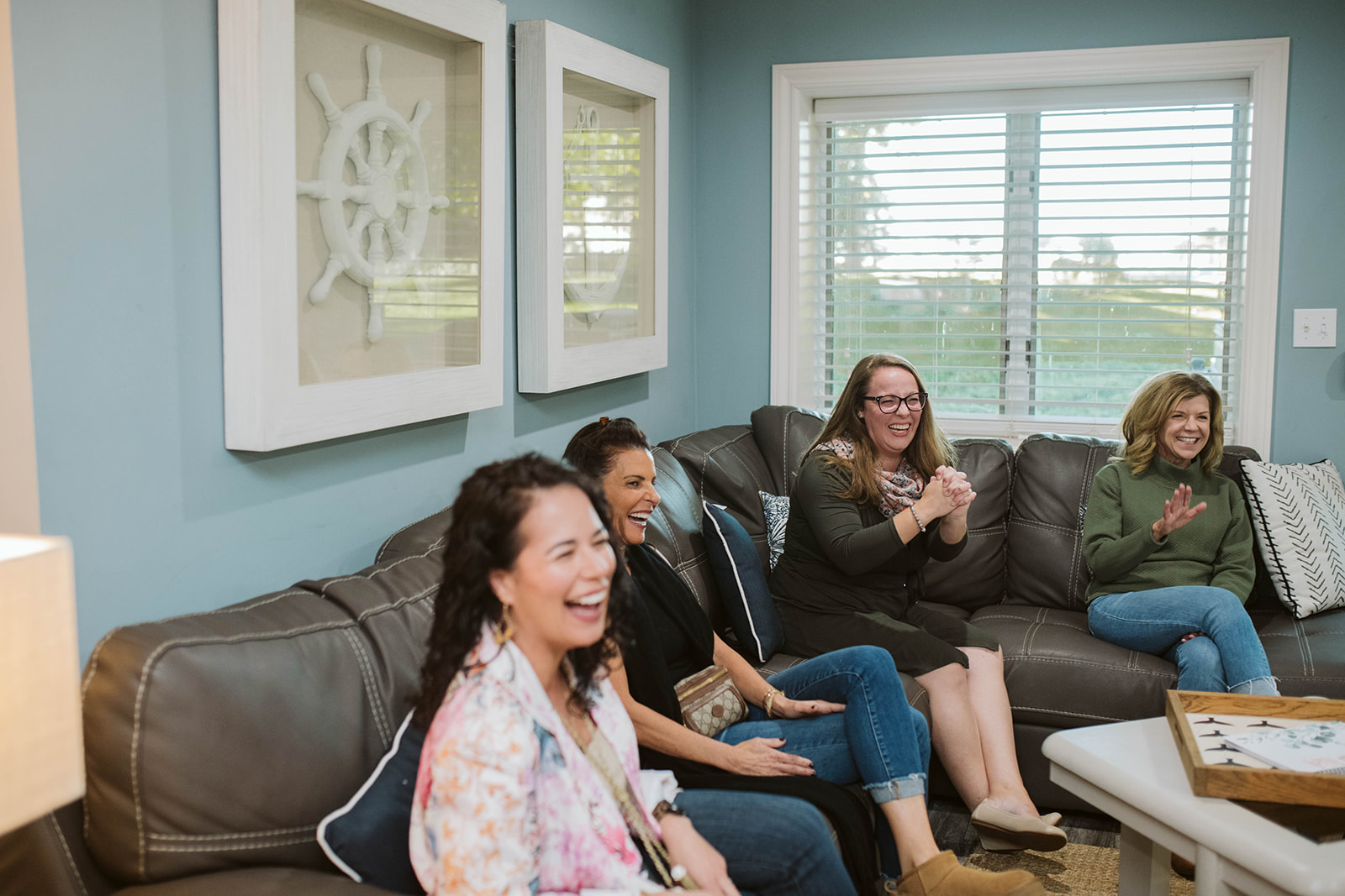 Retreat participants laughing together on the couch